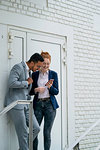 Couple using smart phone outdoors