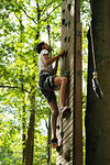 Teenage girl climbing on wall