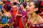 Close-up of women in traditional dresses, dancing down the street in the La Resena Parade in San Miguel de Allende, Guanajuato, Mexico