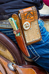 Close-up of cowboy's belt with knife and cell phone holder at a St Michael Archangel Festival parade in San Miguel de Allende, Mexico