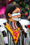Indigenous female, tribal dancer with face paint at a St Michael Archangel Festival parade in San Miguel de Allende, Mexico