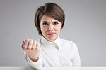 angry woman menacing to punch you in the face and hit you if you keep on in that way