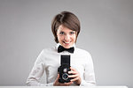 happy photographer in bow tie with a vintage twin-lens reflex camera