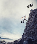 Businessman climb a mountain with a small car to get to the flag. Achievement business goal and Difficult career concept