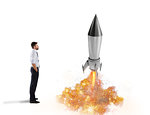 Startup of a new company of a businessman with starting rocket. Concept of business growth