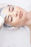 Modern equipment. Cosmetic procedure. Ultrasonic cleaning of the face.Young girl.