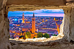 Verona historic skyline evening view through stone window, tourist destination in Veneto region of Italy