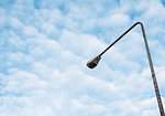 High street light pole under the couldy sky near the urban area.(Copy space).