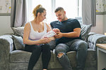 Couple cradling baby on sofa