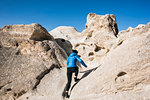 Woman exploring rock formations, Göreme, Cappadocia, Nevsehir, Turkey