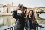 Couple taking selfie on bridge, Ponte Vecchio, Firenze, Toscana, Italy