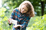 Mid adult woman selecting seeds to plant in her garden