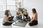 Friends talking in yoga studio