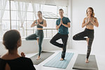 Yoga instructor teaching yoga in studio