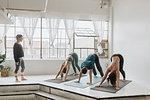 Yoga instructor teaching yoga in studio