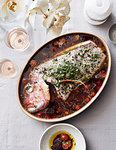 Fish cooked in tomatoes served with rose wine