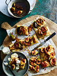 Pieces of figs on crackers served on cutting board