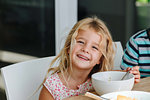 Happy little girl finishing lunch at home