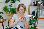 Businesswoman using cellular phone in office