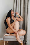 Woman in lingerie posing on chair in room