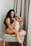 Woman in lingerie posing on chair in room