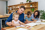 Parents helping children with homework at home