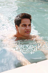 Man swimming to edge of pool