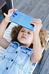 Little girl using smartphone on bench