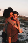 Couple enjoying view of sunset on beach