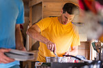 Friends preparing breakfast inside motorhome