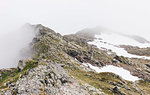 Fog and snow on rocky mountain ranges, Gmund, Tirol, Austria
