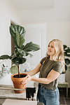 Woman admiring her house plant