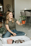 Woman repotting houseplants