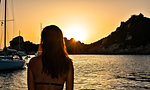 Woman enjoying sunset at sea, La Maddalena island, Sardegna, Italy