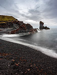 Volcanic rock formations on black sand beach, Snaefellsbaer, Vesturland, Iceland