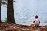 Boy playing near lake