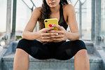 Woman using smartphone on steps