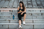 Young woman using smartphone on stairways