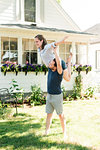 Woman flying on man's shoulder in garden