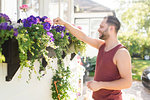 Man tending to flowers in garden