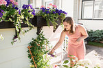 Woman tending to flowers in garden