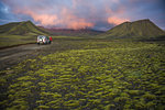 Hiker exploring mossy landscape, Landmannalaugar, Highlands, Iceland