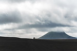 Off road vehicle, volcano in distance, Landmannalaugar, Iceland