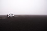 Off road vehicle on dirt track in foggy conditions, Landmannalaugar, Iceland