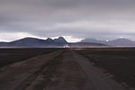 Off road vehicle on dirt track heading to hills, Landmannalaugar, Iceland