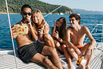 Friends taking selfie on sailboat, Italy