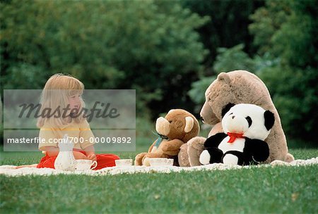 Girl with Stuffed Toys Outdoors