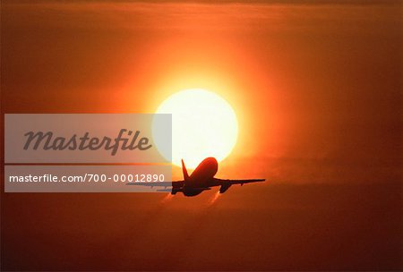 Silhouette of Airplane Taking Off At Sunset