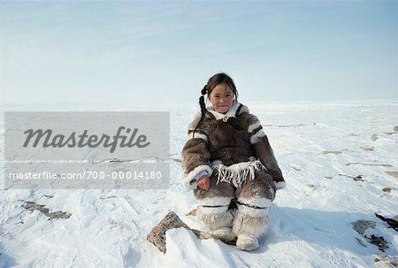 Portrait of Girl Sitting on Rock In Snow Northwest Territories, Canada