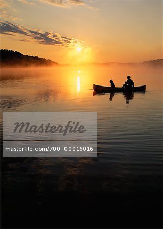 Silhouette of People in Boat on Lake Chandos at Sunset Ontario, Canada